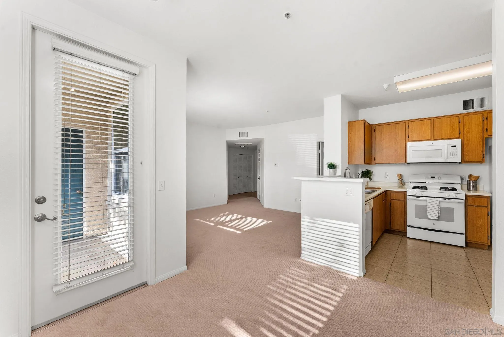 1441 Santa Lucia Road, Unit 615 Chula Vista, CA 91913 - Photo 5 of 31 a kitchen with white cabinets and white appliances