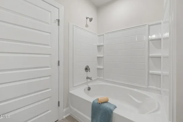 a bathroom with a bathtub and shower