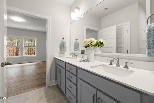 a bathroom with a sink double vanity and a mirror