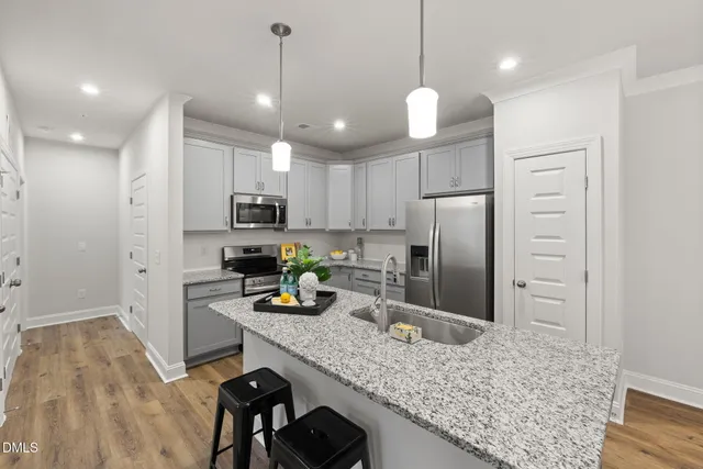 a kitchen with refrigerator and center island