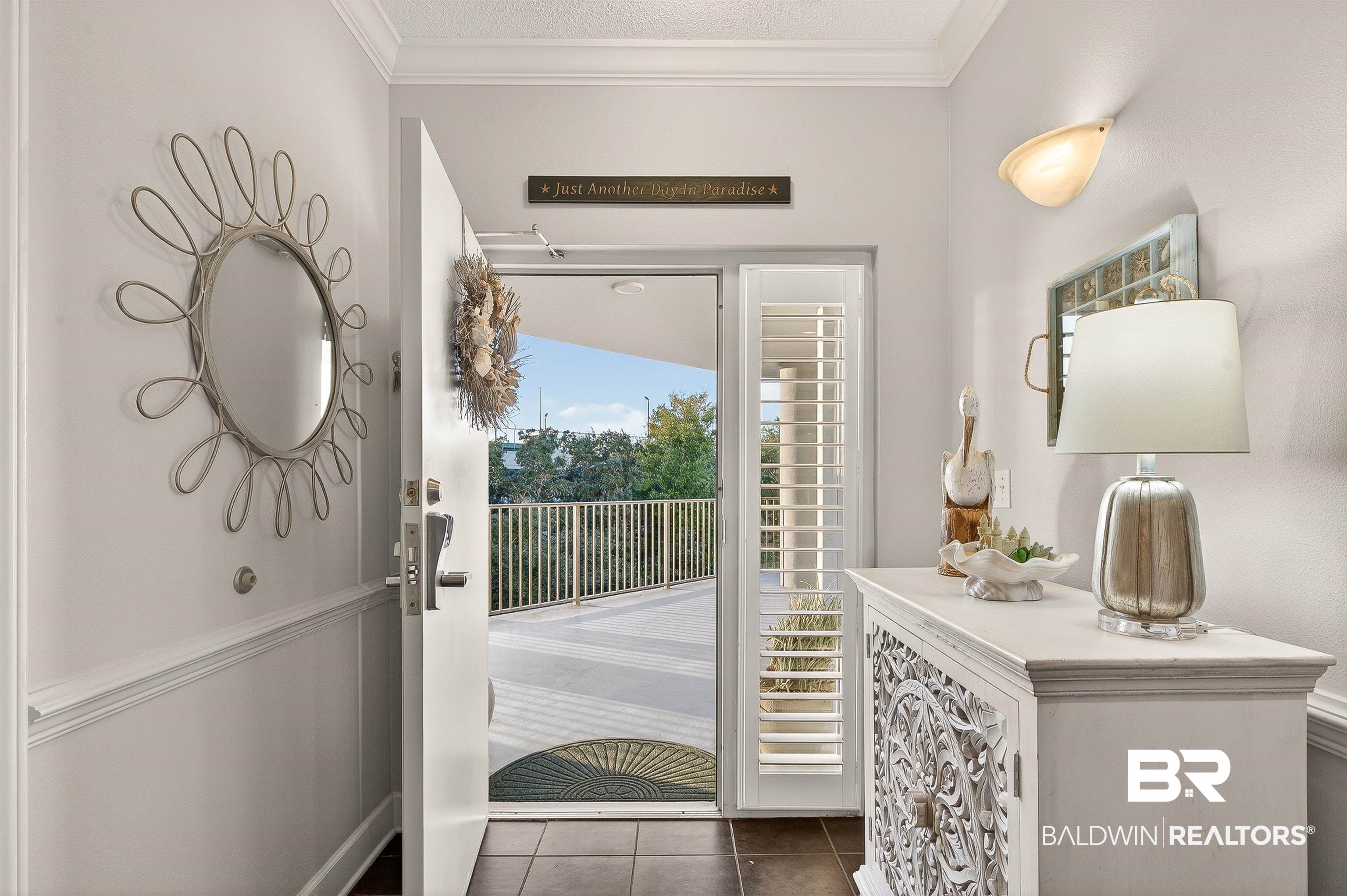 27582 Canal Road, Unit 2507 Orange Beach, AL 36561 - Photo 8 of 75 Entryway featuring crown molding, dark tile patterned floors, and a textured ceiling
