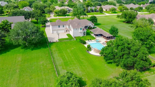 an aerial view of a house with a yard