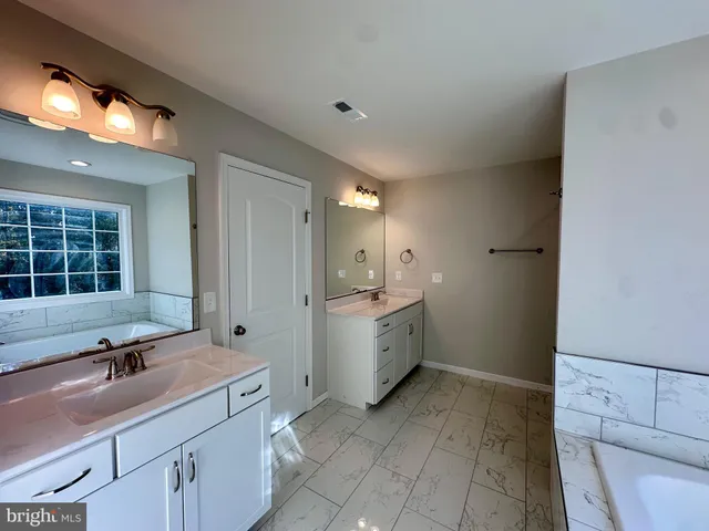 a bathroom with a bathtub and window