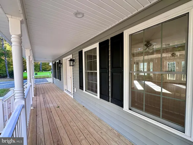 a large kitchen with stainless steel appliances granite countertop a lot of counter space and wooden floor