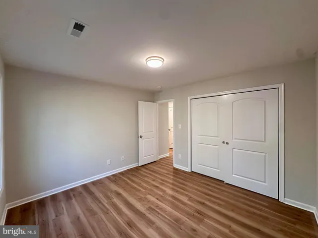 a view of a house with a yard and tree