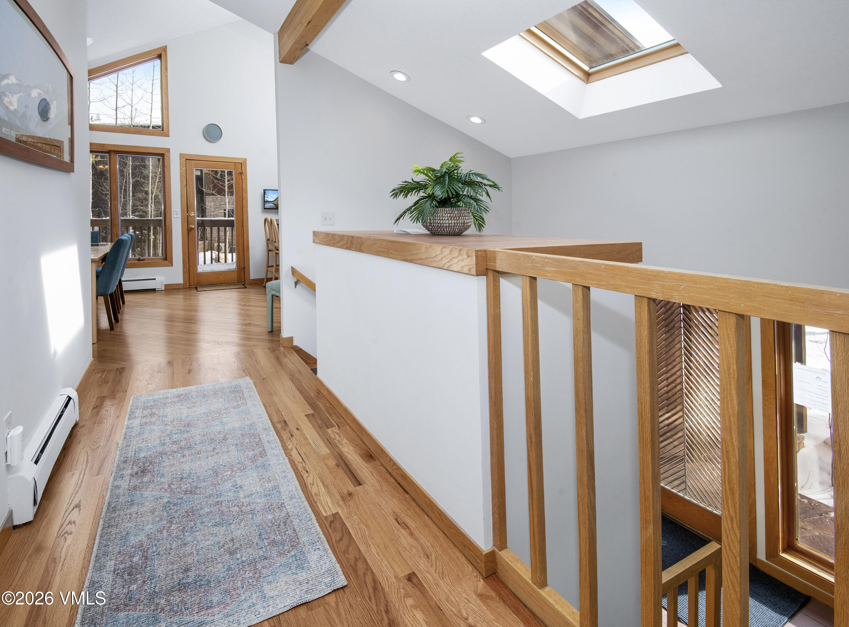 5159 Gore Circle Vail, CO 81657 - Photo 16 of 36 a view of a hallway with wooden floor and staircase