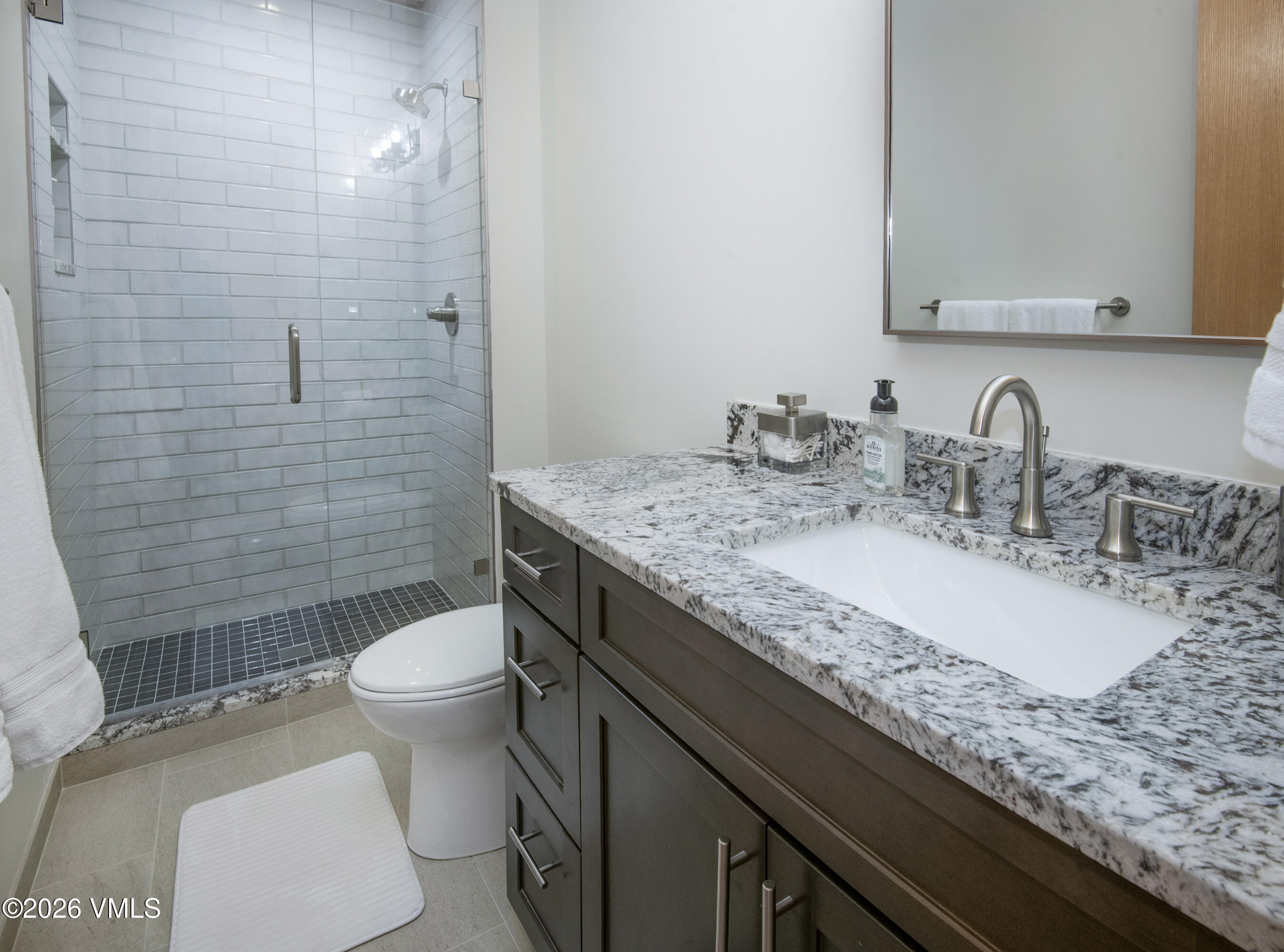 5159 Gore Circle Vail, CO 81657 - Photo 21 of 36 a bathroom with a granite countertop sink toilet and shower