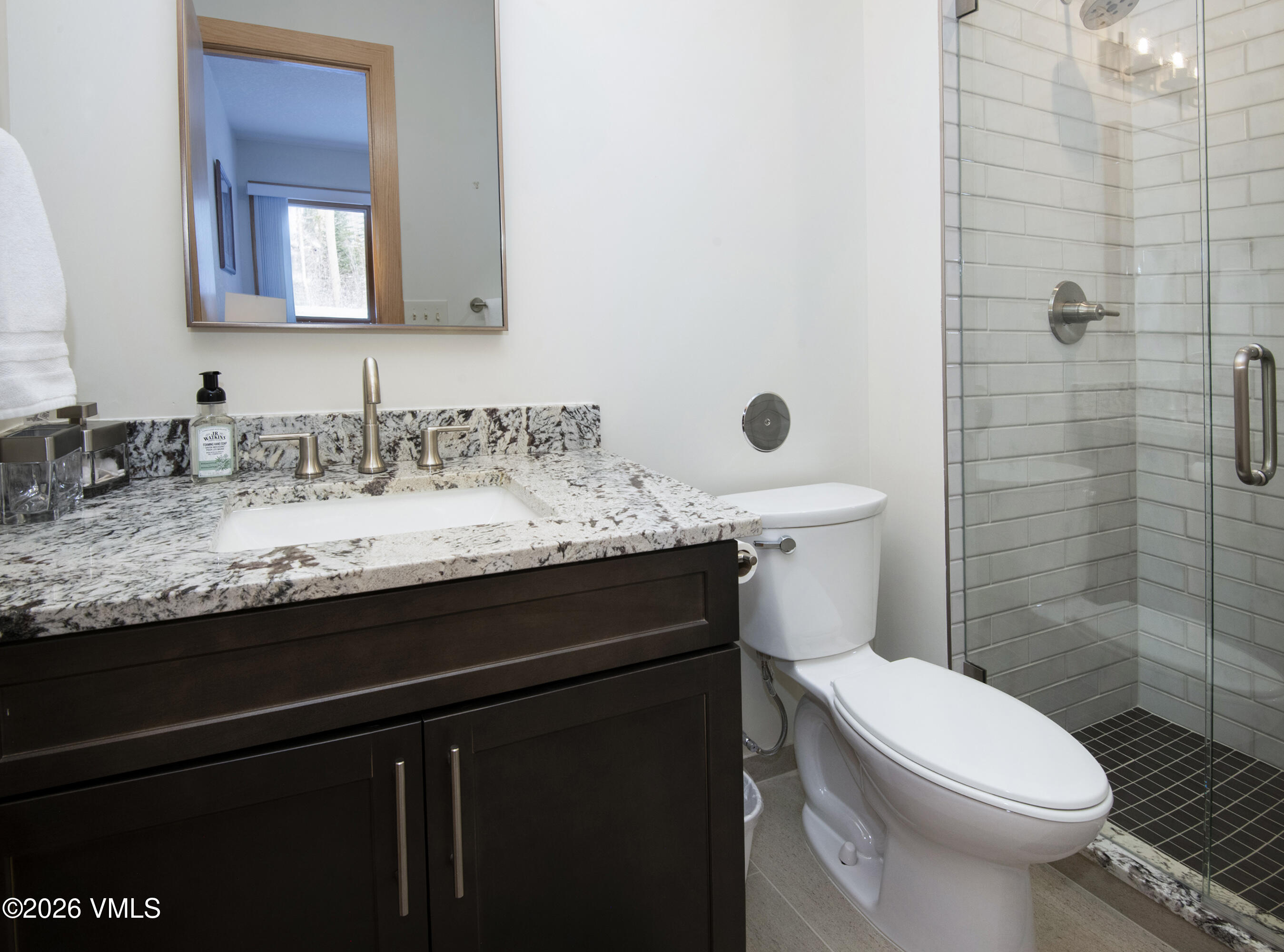 5159 Gore Circle Vail, CO 81657 - Photo 23 of 36 a bathroom with a granite countertop sink toilet and shower