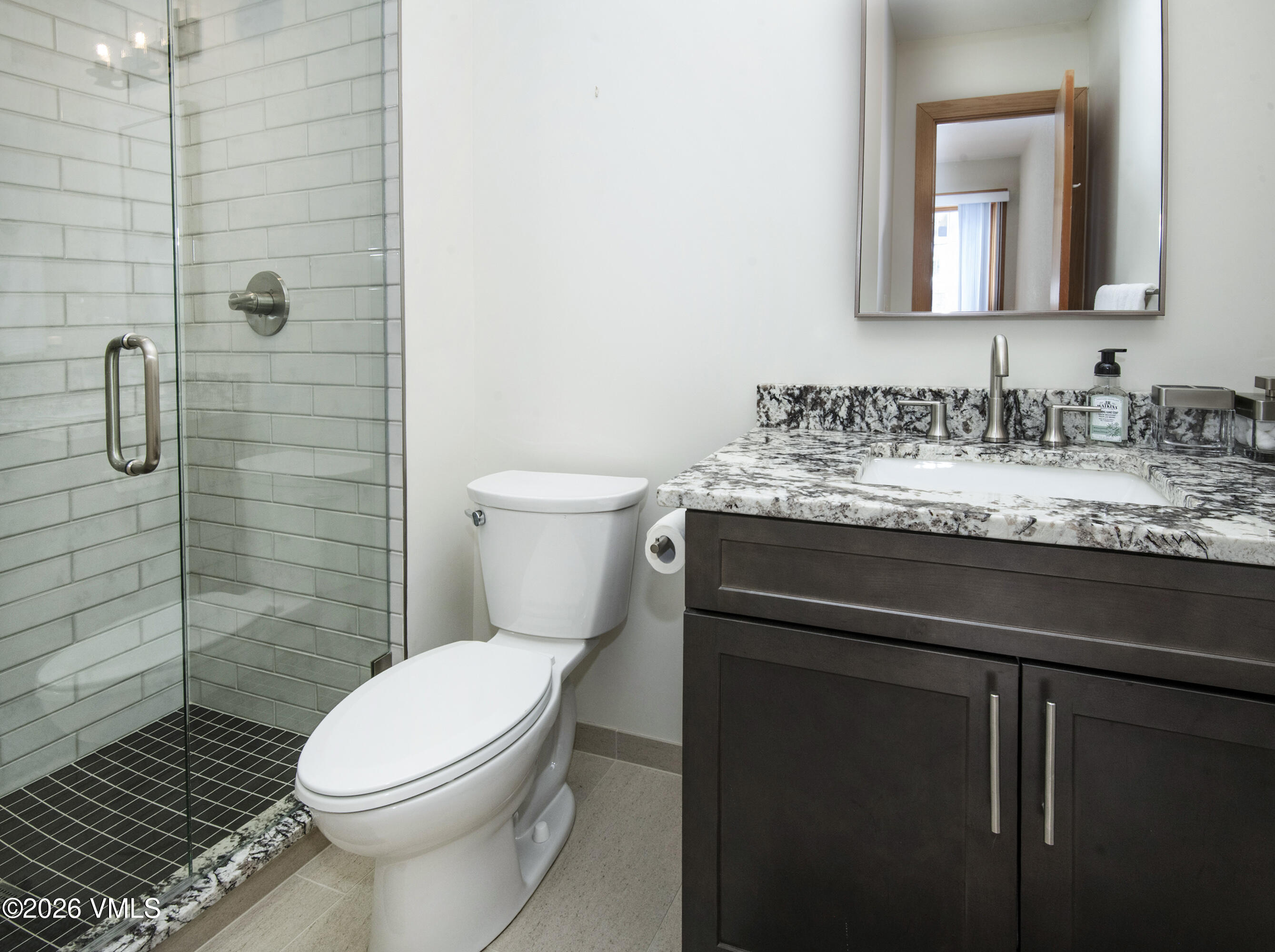 5159 Gore Circle Vail, CO 81657 - Photo 25 of 36 a bathroom with a granite countertop toilet sink and shower