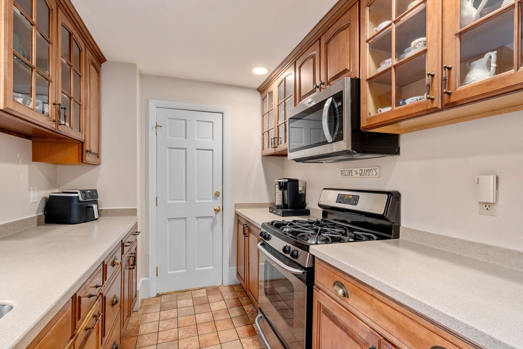 19 Winter Street Arlington, MA 02474 - Photo 11 of 39 a kitchen with stainless steel appliances a stove and a refrigerator