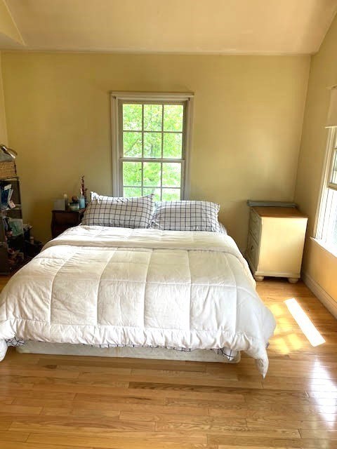 19 Winter Street Arlington, MA 02474 - Photo 36 of 39 a large bed sitting in a bedroom next to a window