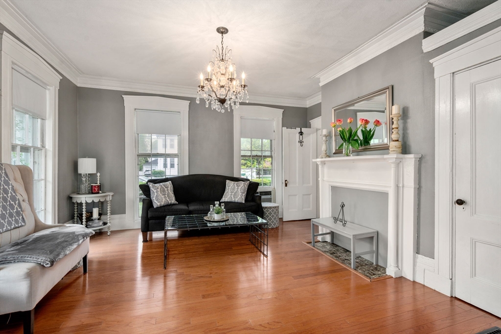 19 Winter Street Arlington, MA 02474 - Photo 6 of 39 a living room with furniture a fireplace and a flat screen tv