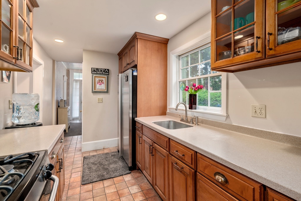 19 Winter Street Arlington, MA 02474 - Photo 10 of 39 a kitchen with stainless steel appliances granite countertop a sink and a refrigerator