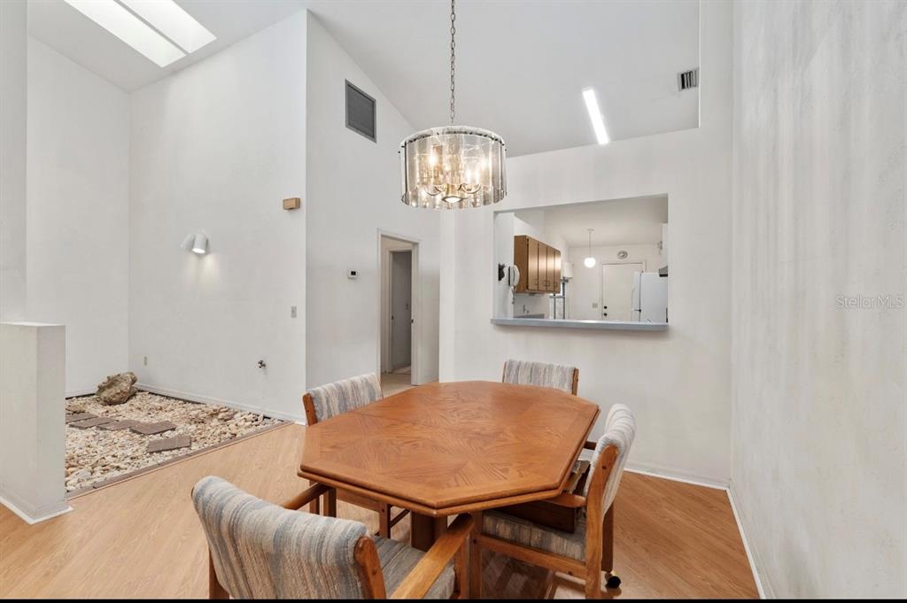 907 Southwest 51 Way Gainesville, FL 32607 - Photo 13 of 45 a view of a dining room with furniture and chandelier