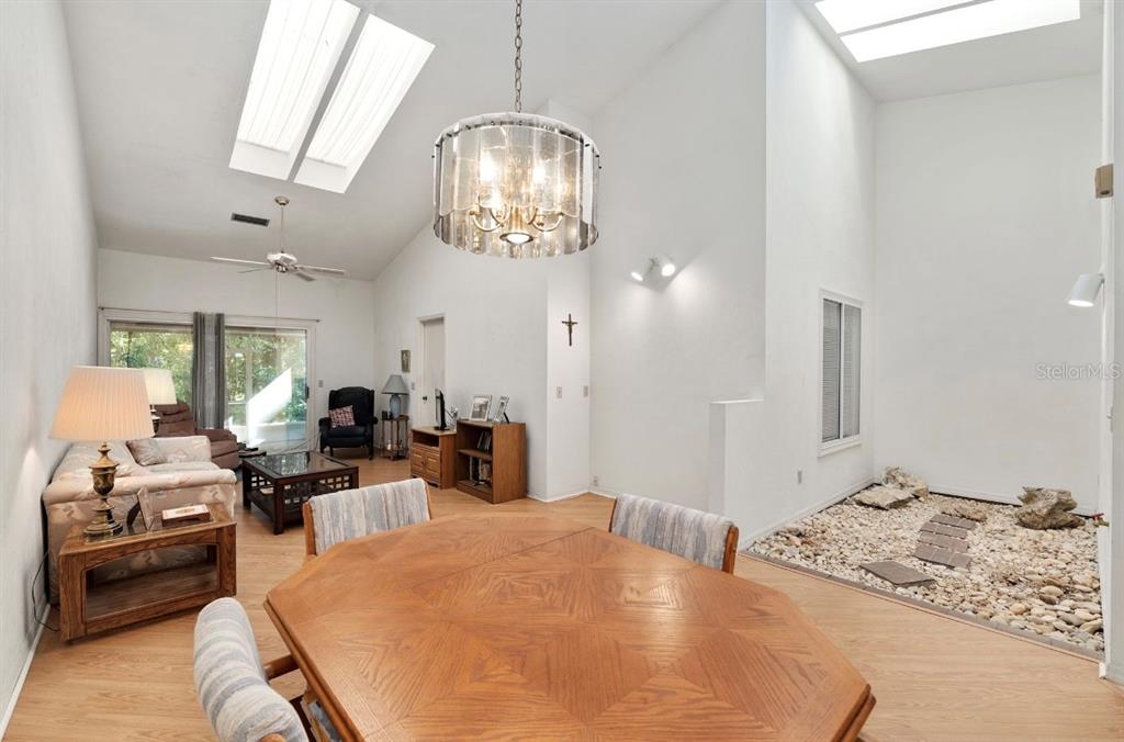 907 Southwest 51 Way Gainesville, FL 32607 - Photo 16 of 45 a bedroom with furniture and a chandelier