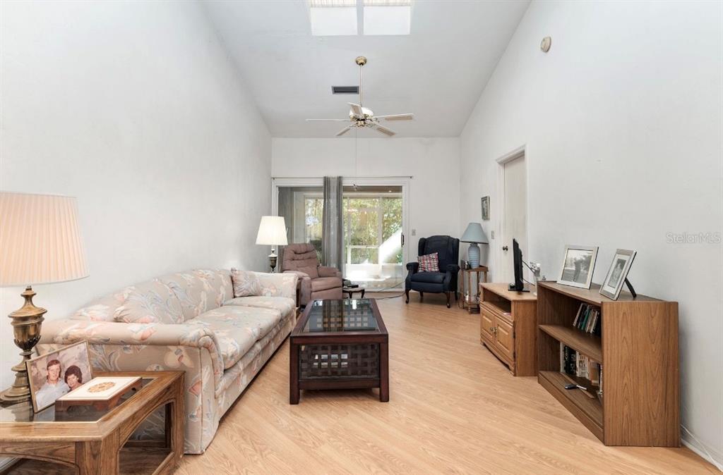 907 Southwest 51 Way Gainesville, FL 32607 - Photo 17 of 45 a living room with furniture a chandelier and a window