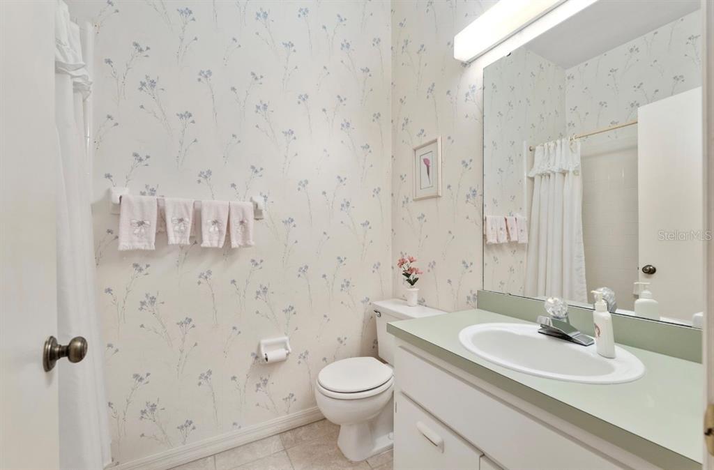 907 Southwest 51 Way Gainesville, FL 32607 - Photo 34 of 45 a bathroom with a granite countertop sink a toilet and a mirror