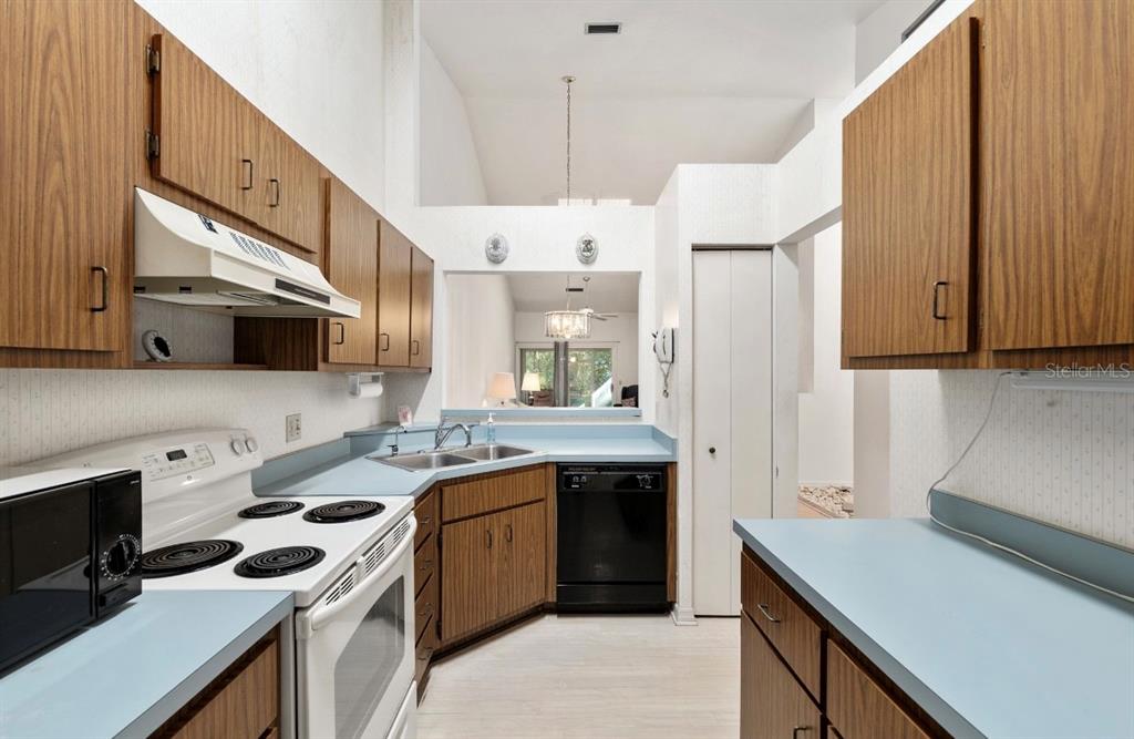 907 Southwest 51 Way Gainesville, FL 32607 - Photo 7 of 45 a kitchen with a sink a stove a refrigerator and a oven