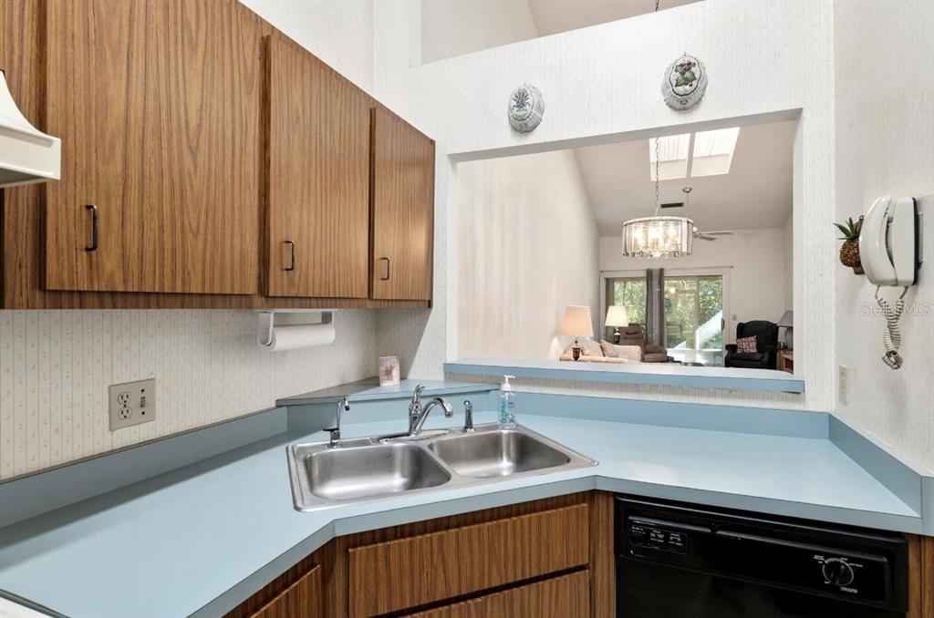 907 Southwest 51 Way Gainesville, FL 32607 - Photo 9 of 45 a kitchen with granite countertop a sink and cabinets