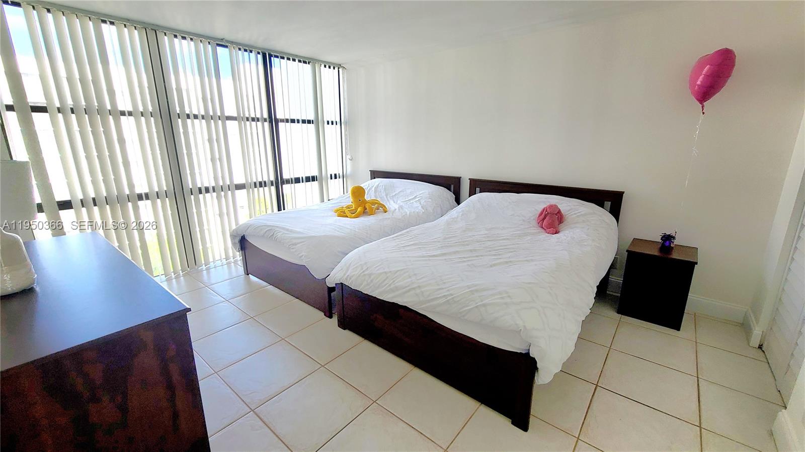 16909 North Bay Road, Unit 806 Sunny Isles Beach, FL 33160 - Photo 11 of 27 a bedroom with a bed and a large window