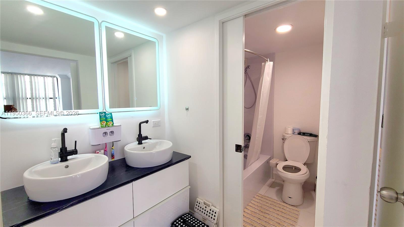 16909 North Bay Road, Unit 806 Sunny Isles Beach, FL 33160 - Photo 14 of 27 a bathroom with a sink and a mirror