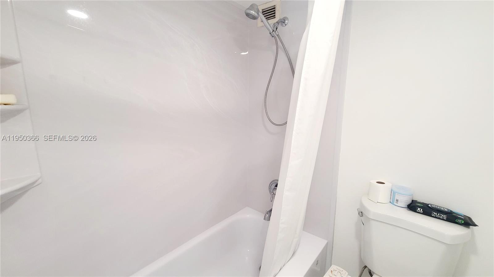 16909 North Bay Road, Unit 806 Sunny Isles Beach, FL 33160 - Photo 15 of 27 a bathroom with a bathtub a toilet and a shower