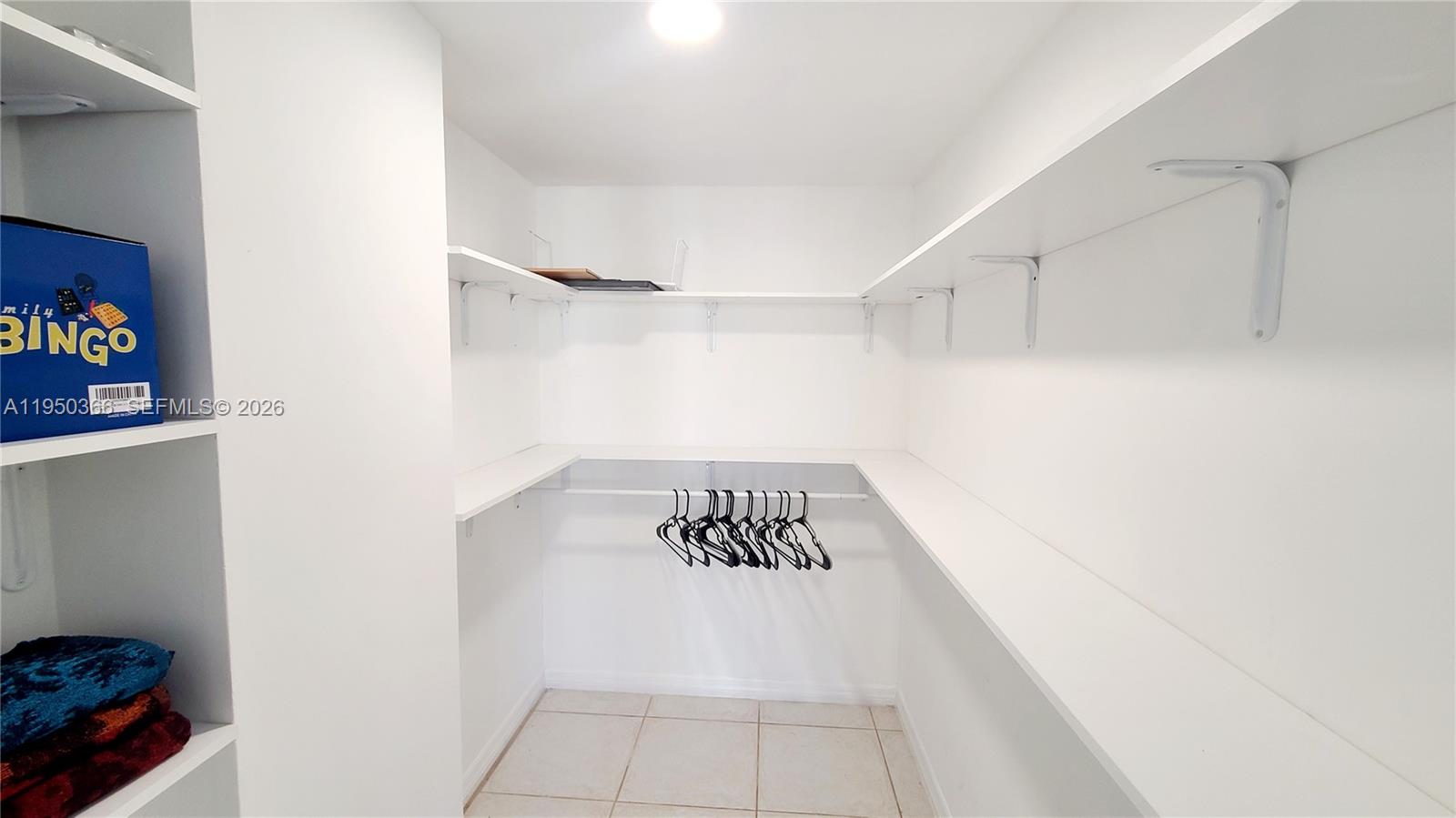 16909 North Bay Road, Unit 806 Sunny Isles Beach, FL 33160 - Photo 21 of 27 a walk in closet with wooden floor