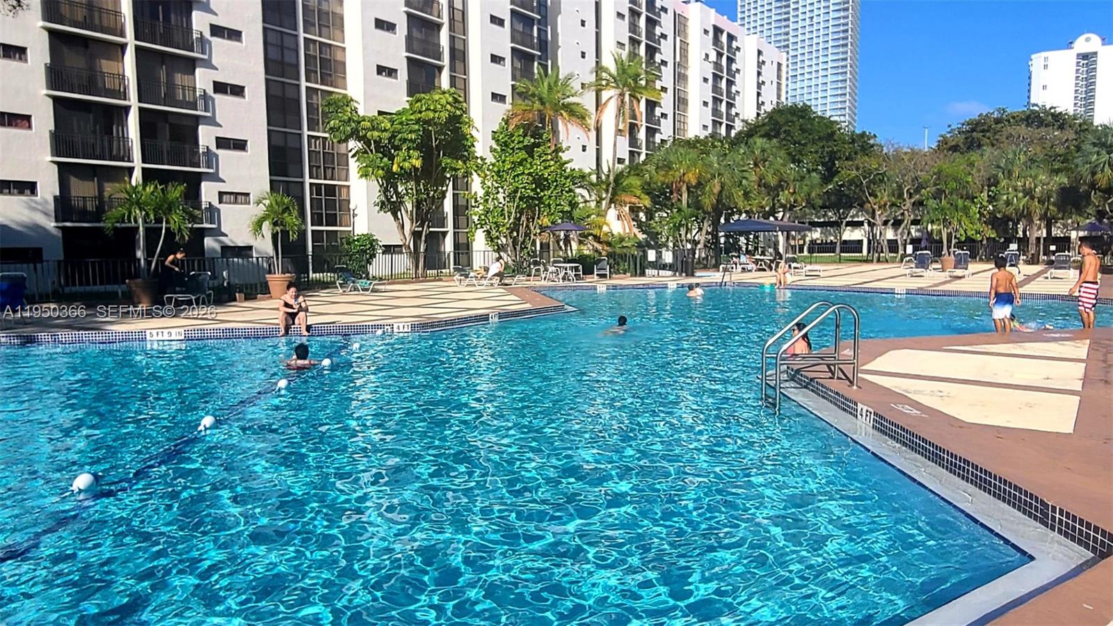 16909 North Bay Road, Unit 806 Sunny Isles Beach, FL 33160 - Photo 25 of 27 a swimming pool with outdoor seating and yard