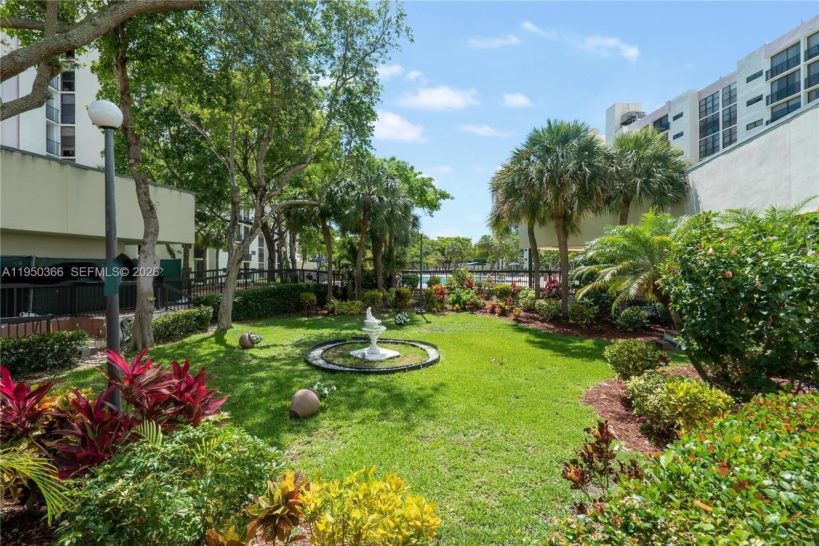 16909 North Bay Road, Unit 806 Sunny Isles Beach, FL 33160 - Photo 27 of 27 a view of a backyard with sitting area and tree