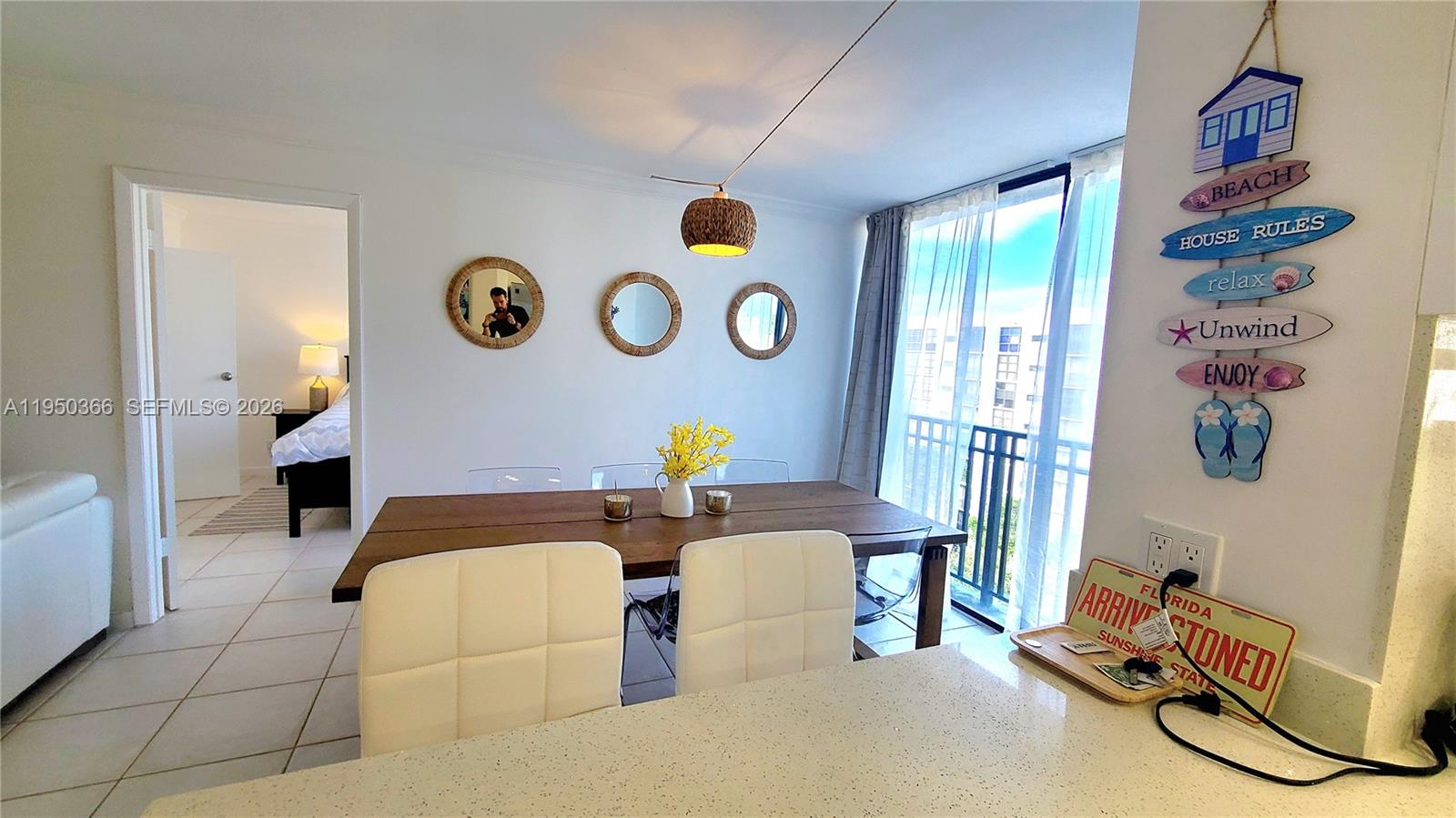 16909 North Bay Road, Unit 806 Sunny Isles Beach, FL 33160 - Photo 8 of 27 a living room with furniture and a window