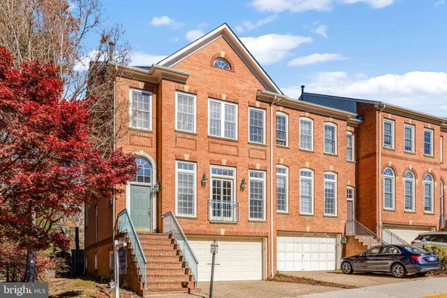 a front view of a residential apartment building with a yard