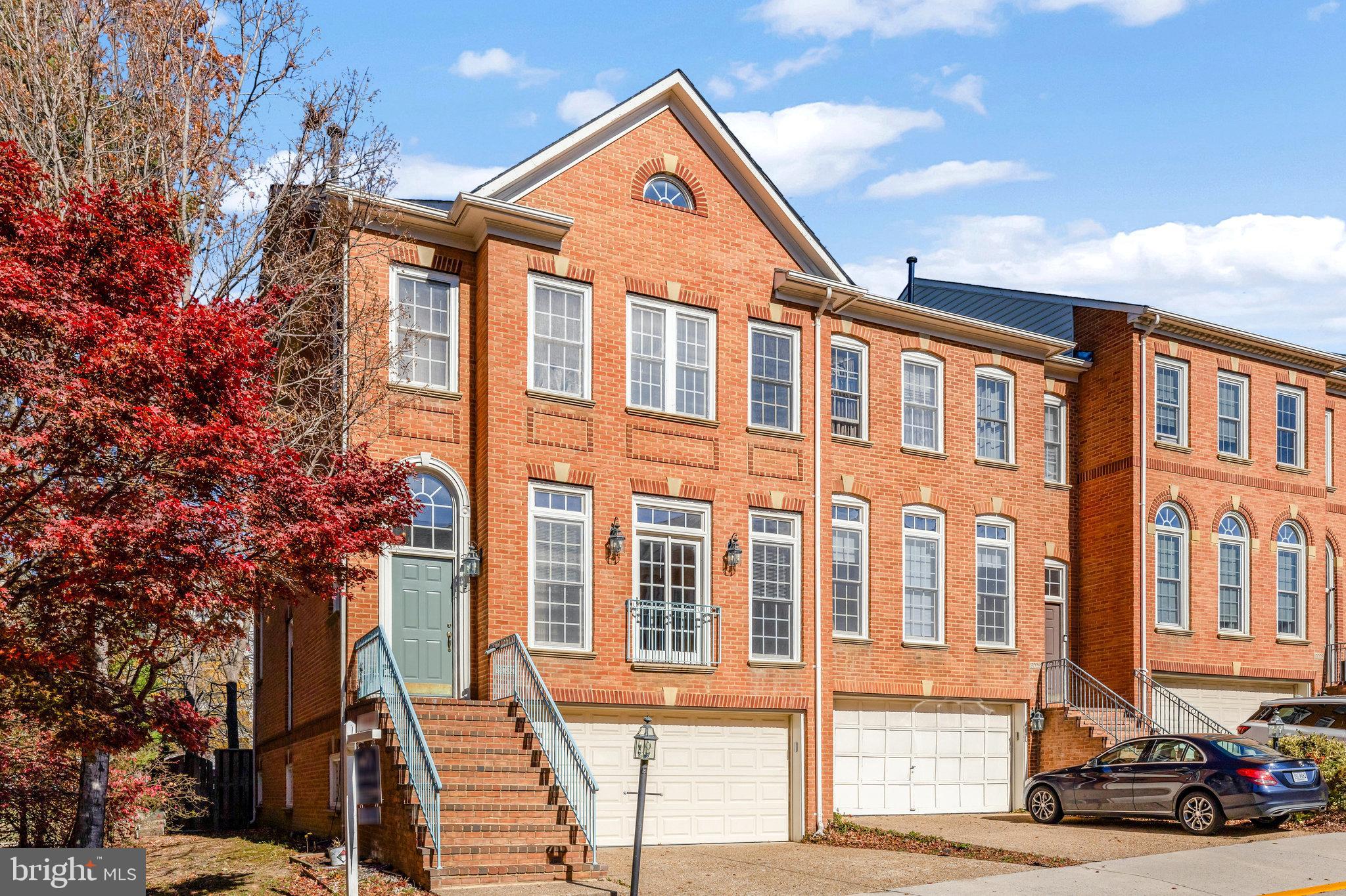 a front view of a residential apartment building with a yard
