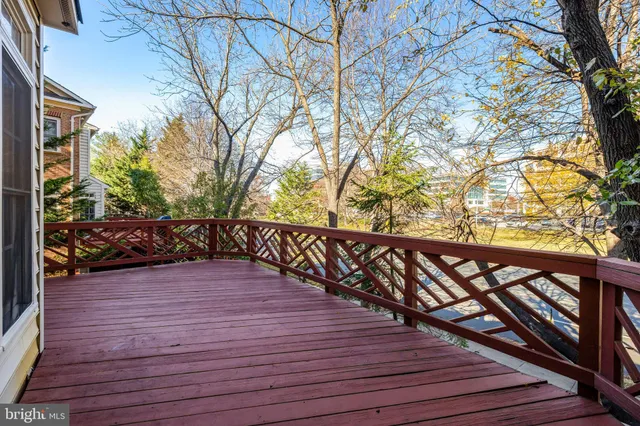 a view of staircase with white walls and door