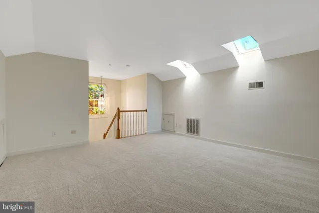 a view of staircase with white walls and railing