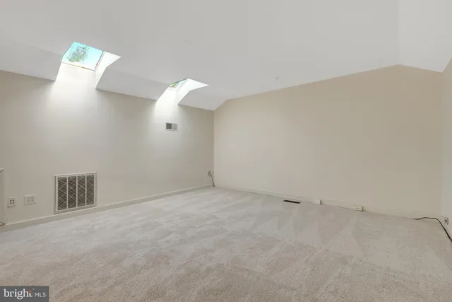 a view of a livingroom with furniture and an empty room