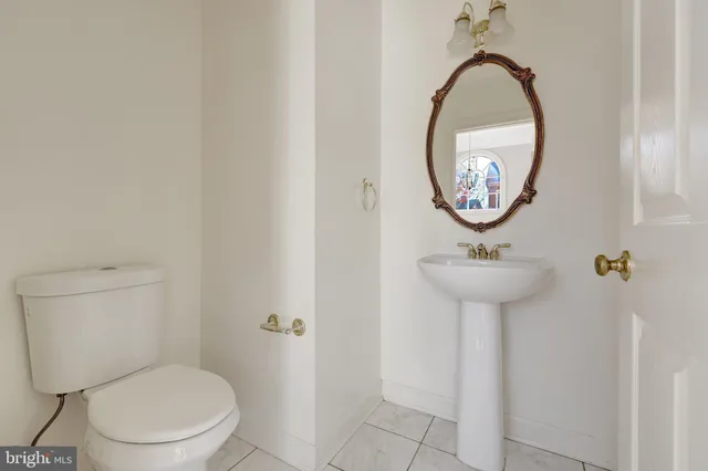 a view of a bedroom with wooden floor and windows