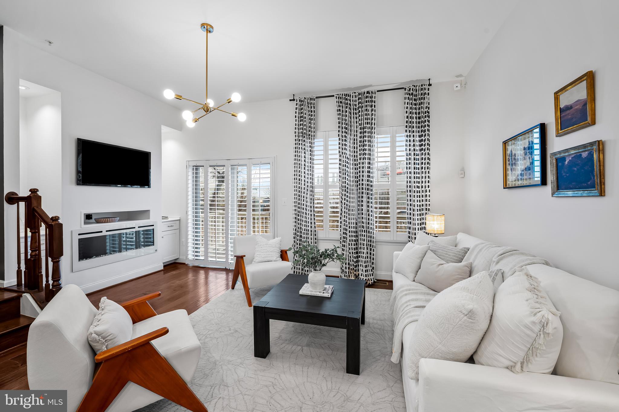 1602 Rampart Mews Baltimore, MD 21230 - Photo 2 of 49 Bright open living room with fireplace and deck