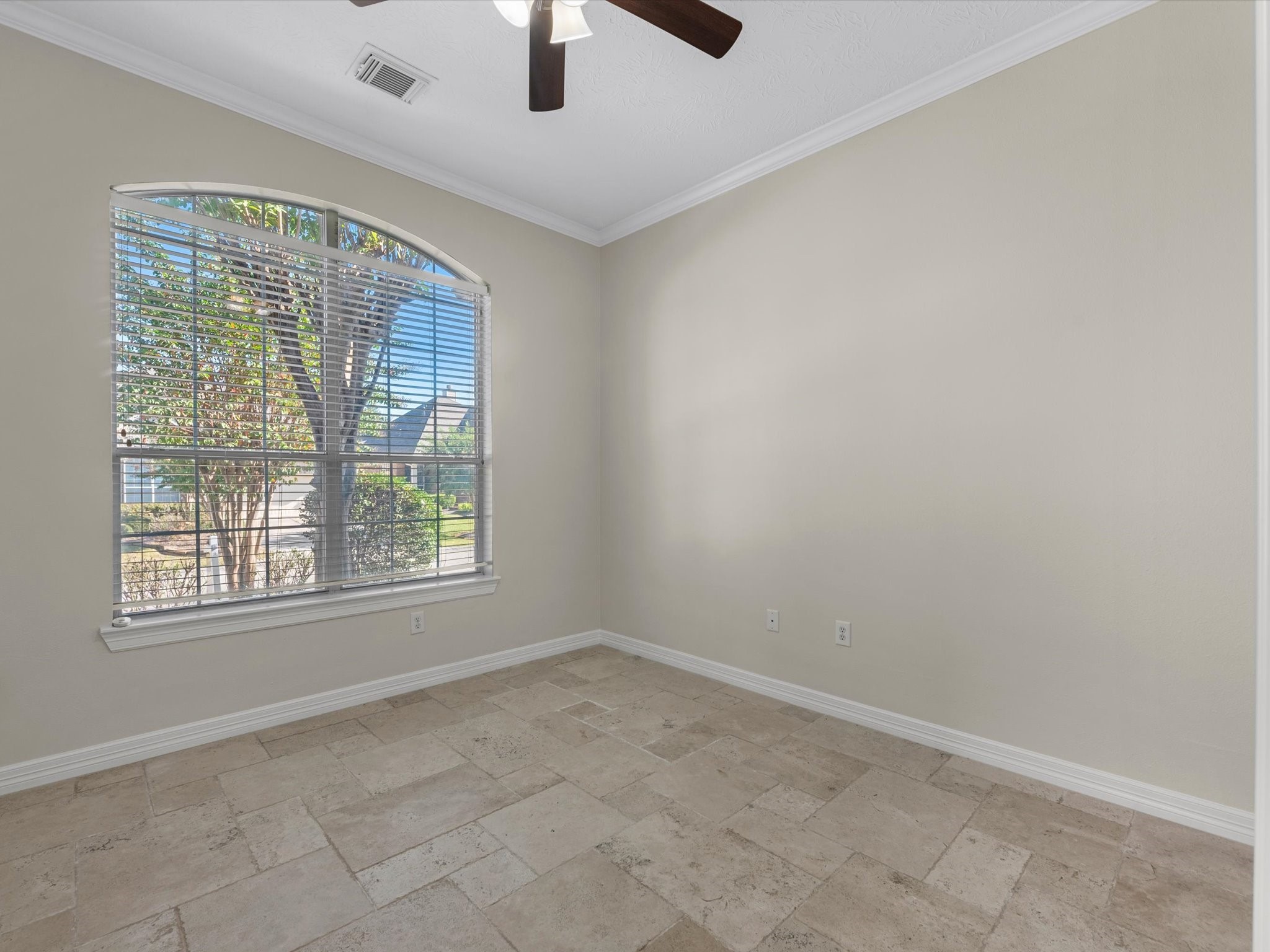 31 Tarrytown Way Conroe, TX 77384 - Photo 16 of 41 an empty room with chandelier fan and windows