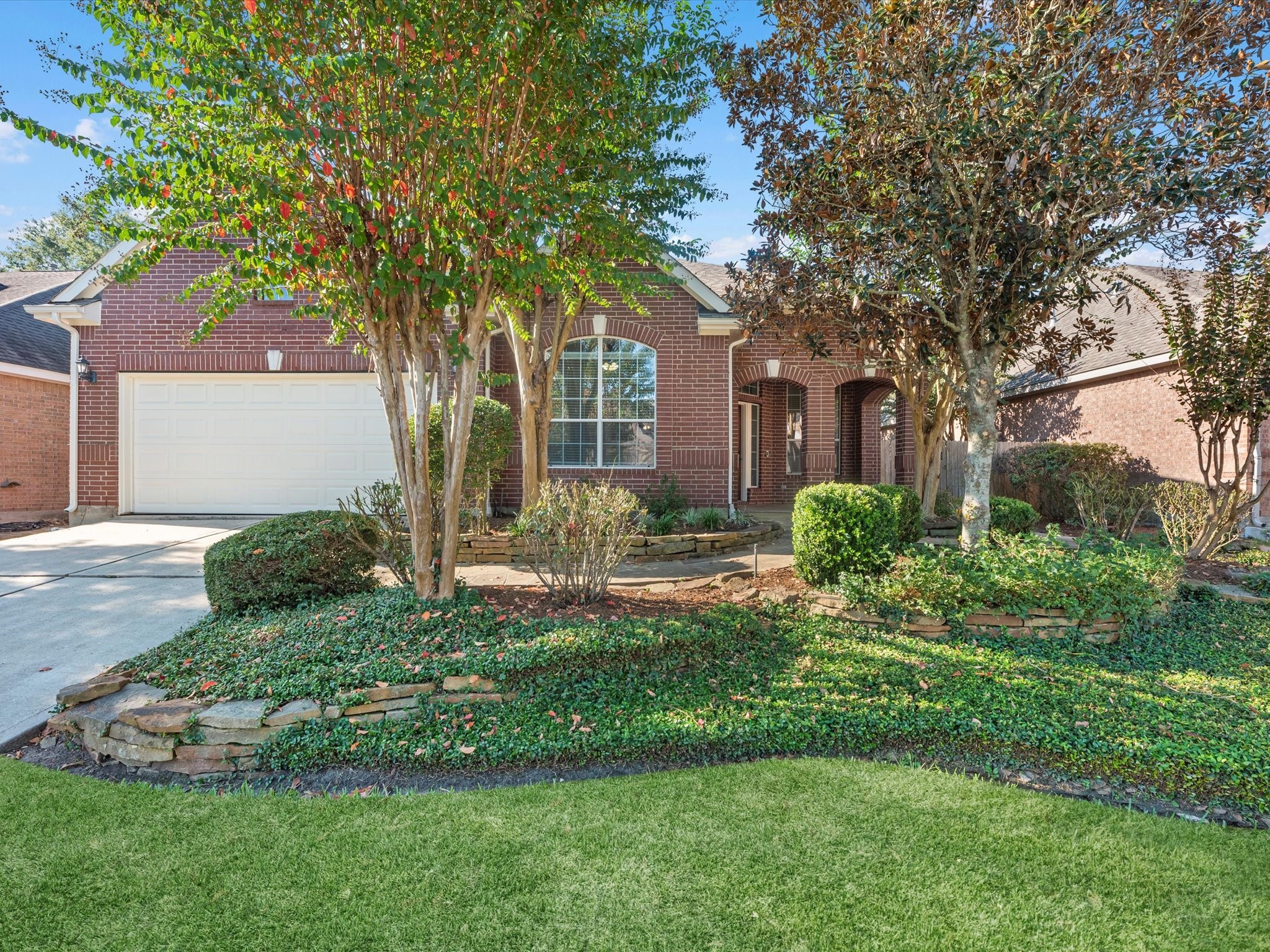 31 Tarrytown Way Conroe, TX 77384 - Photo 2 of 41 a front view of a house with a yard and garage