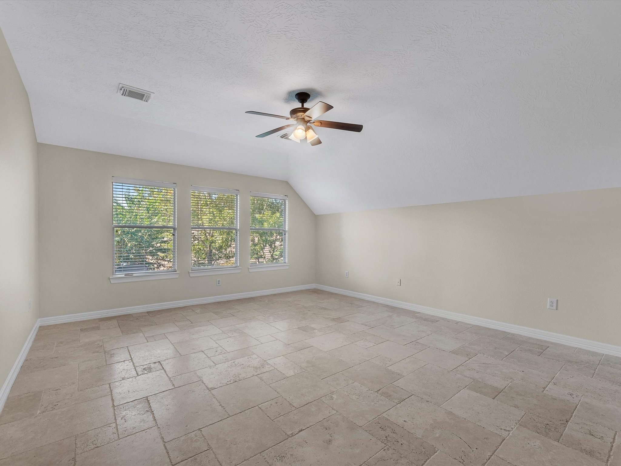 31 Tarrytown Way Conroe, TX 77384 - Photo 26 of 41 an empty room with windows and fan