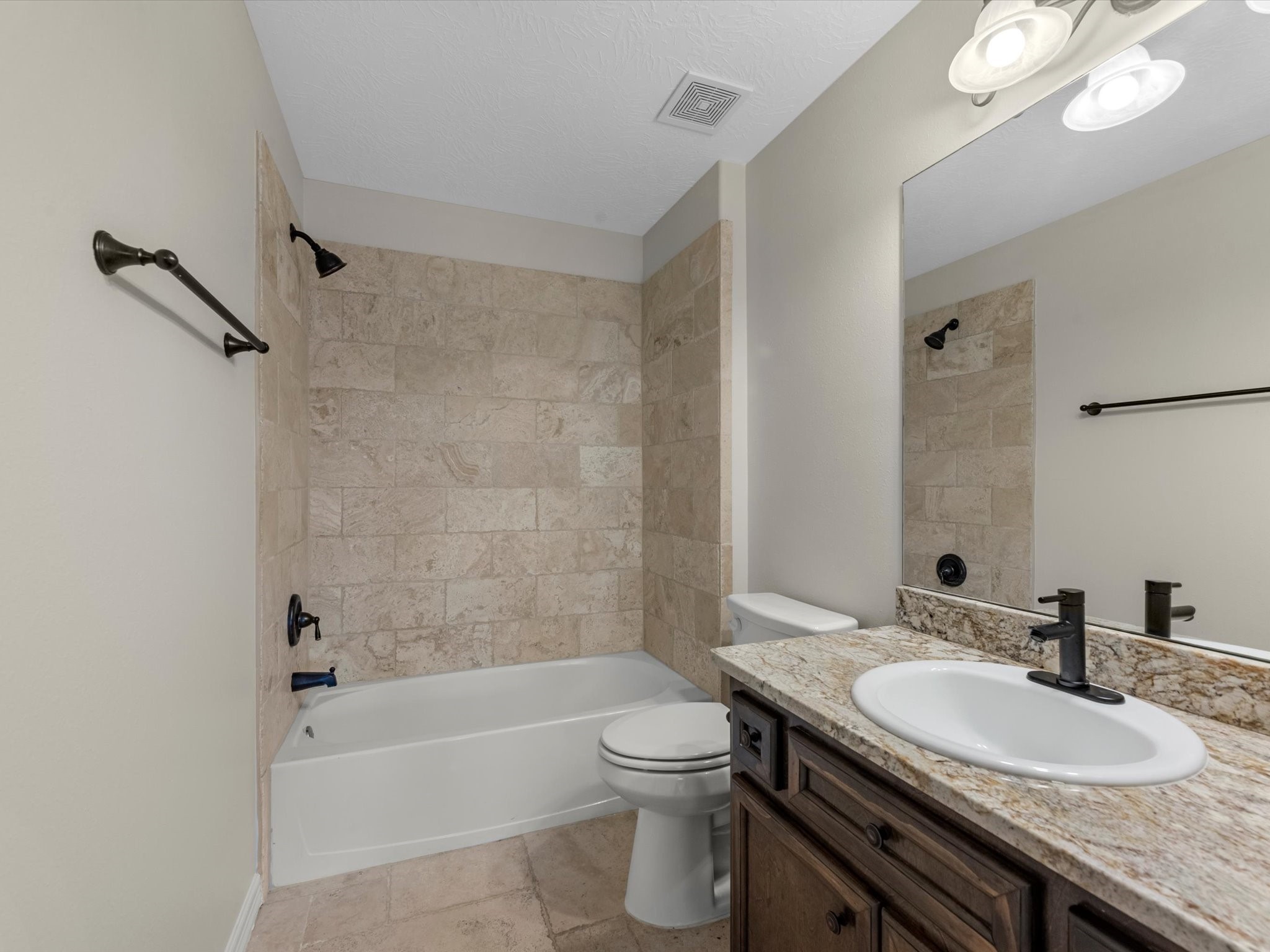 31 Tarrytown Way Conroe, TX 77384 - Photo 28 of 41 a bathroom with a granite countertop sink a toilet tub and shower