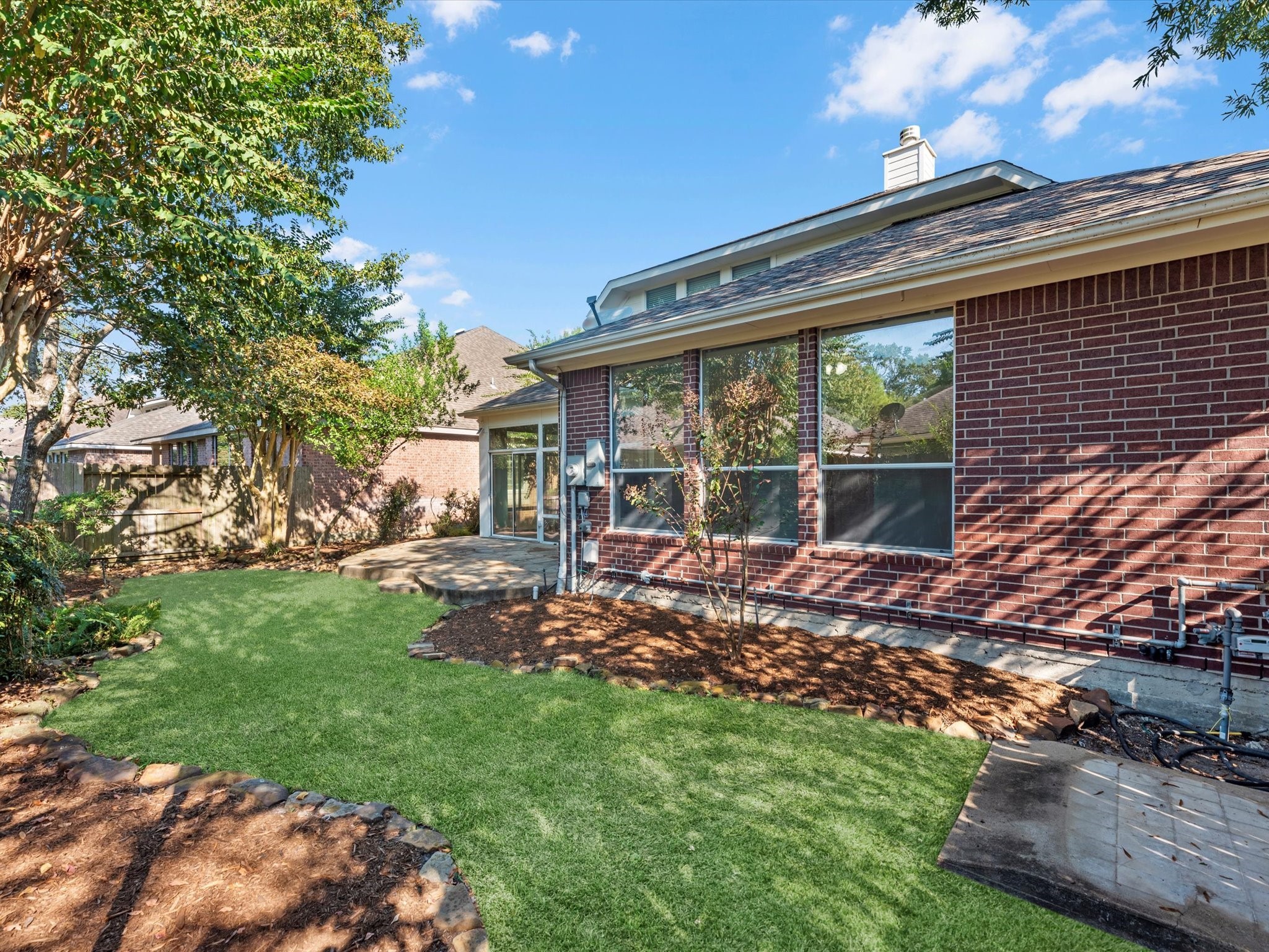 31 Tarrytown Way Conroe, TX 77384 - Photo 37 of 41 a view of a house with backyard sitting area and garden