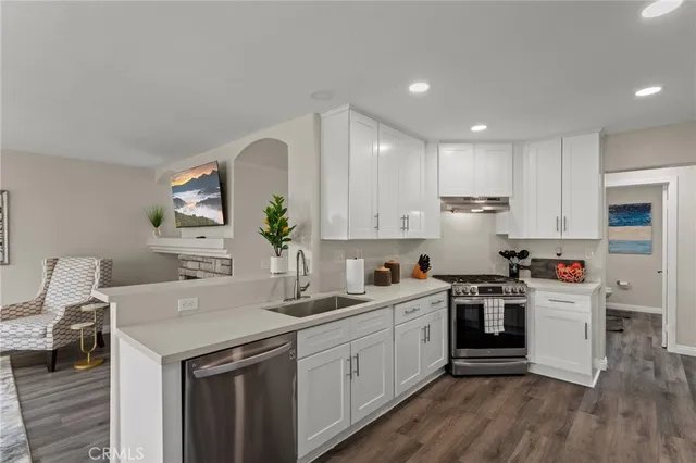 a kitchen with a sink a stove and cabinets