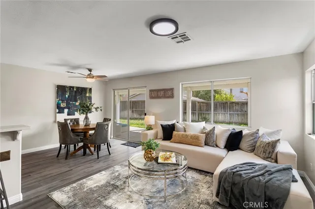 a living room with furniture and a wooden floor