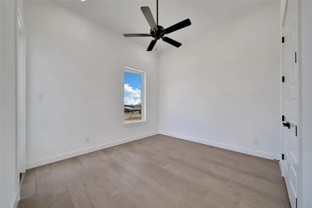 a view of room with a ceiling fan and window