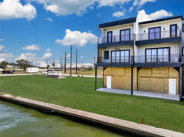 a house view with swimming pool and garden