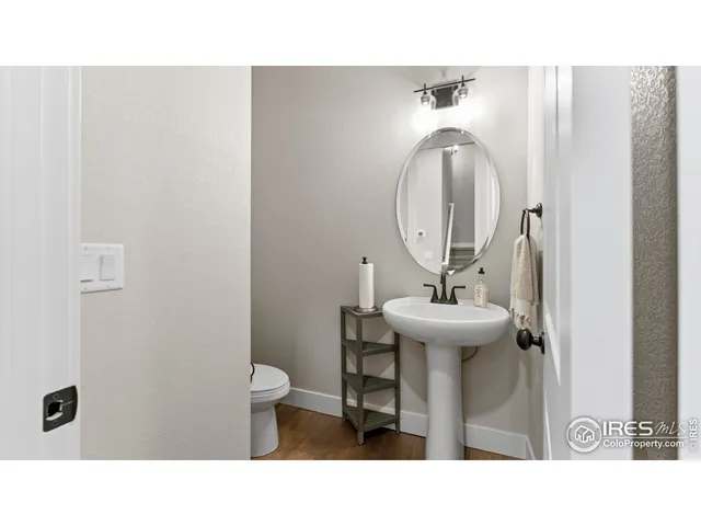 a bathroom with a sink toilet and a mirror