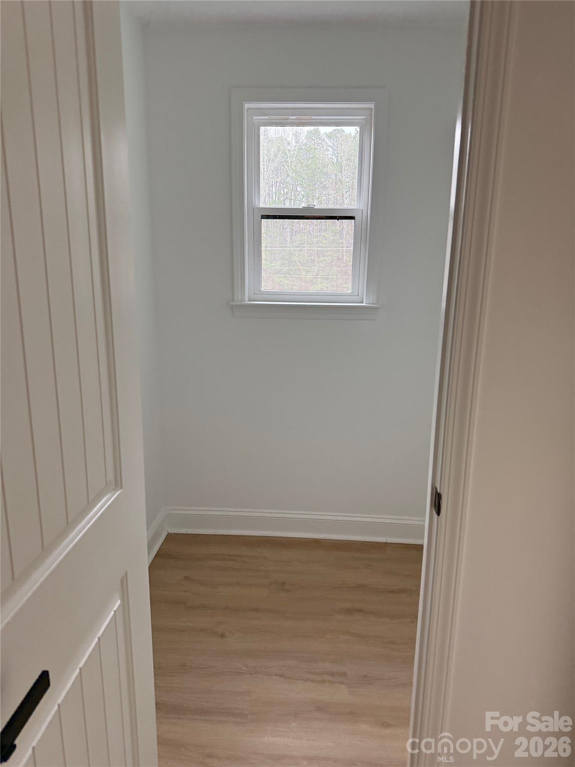 2170 Neel Road Salisbury, NC 28147 - Photo 17 of 21 a view of an empty room with wooden floor and a window