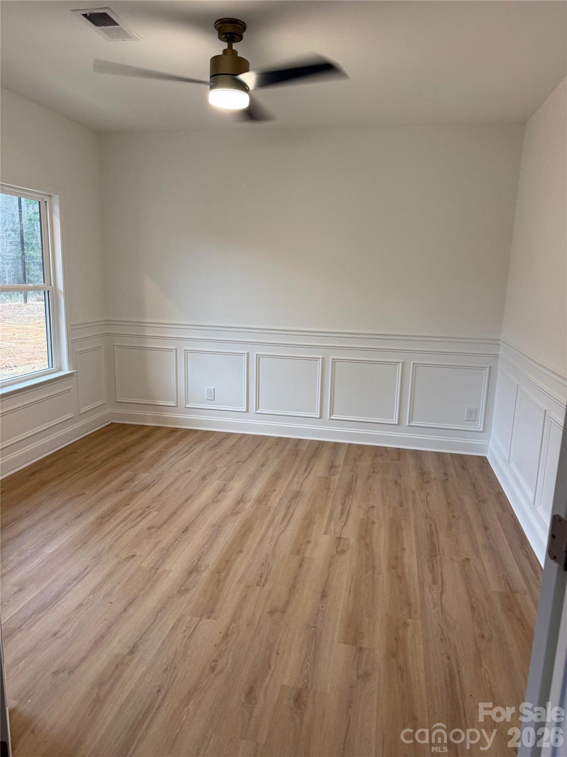 2170 Neel Road Salisbury, NC 28147 - Photo 4 of 21 a view of an empty room with wooden floor and a window