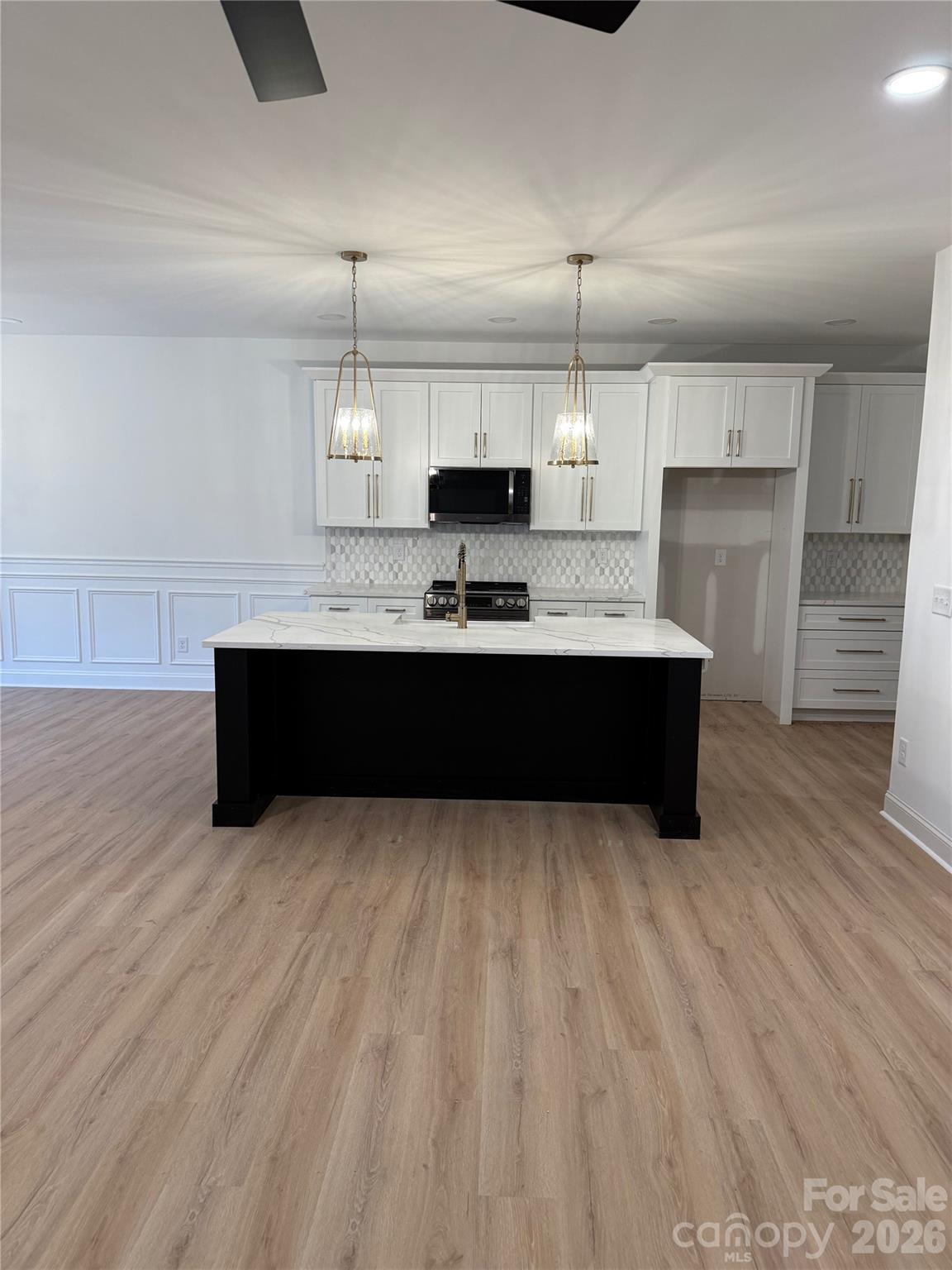2170 Neel Road Salisbury, NC 28147 - Photo 5 of 21 a kitchen with kitchen island a sink and a stove top oven
